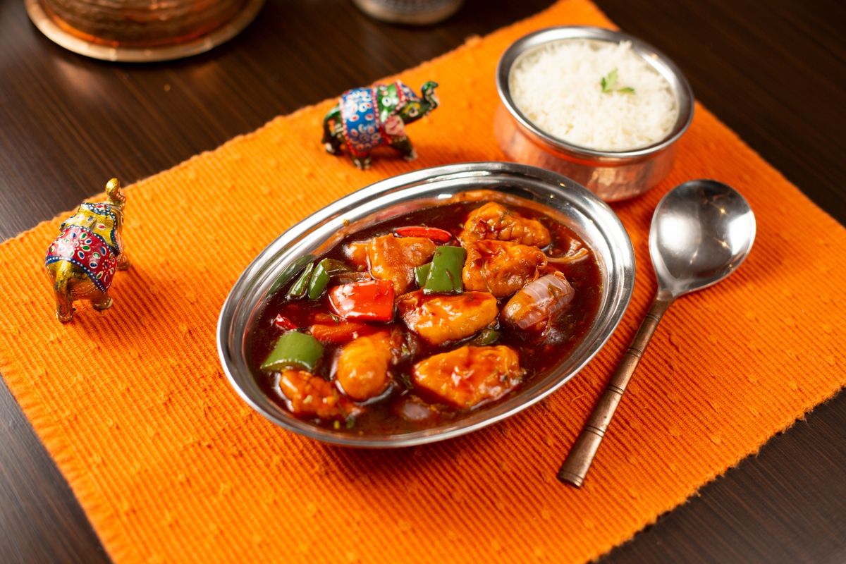 Chilli Chicken with peppers and onions in a spicy glaze, served with rice