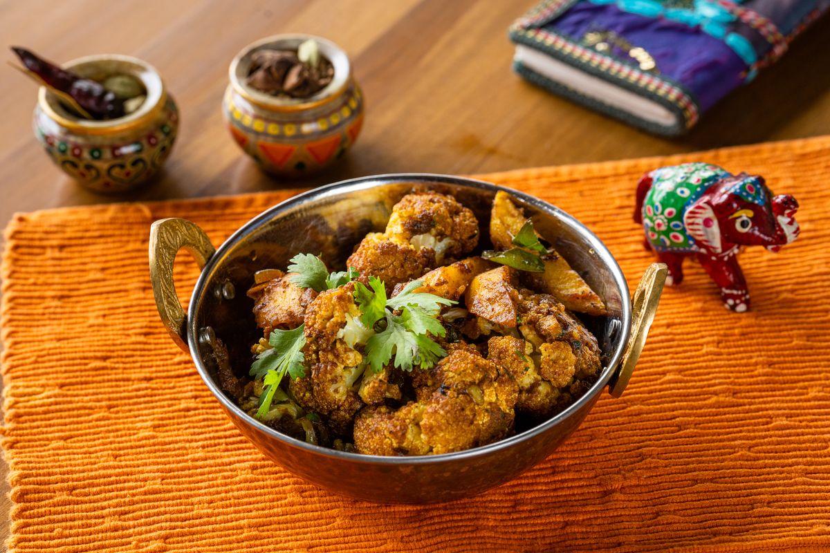 Crisp-fried cauliflower Gobi Masala garnished with fresh cilantro