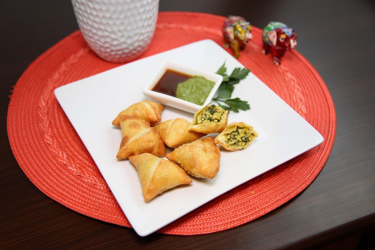Crisp vegetable samosas served with tamarind and mint chutney